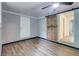 Bedroom with a sliding barn door, ceiling fan, and gray painted-brick walls at 122 Vickery Dr, Fairburn, GA 30213