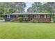 Charming single-story brick home with a vibrant lawn and manicured landscaping at 122 Vickery Dr, Fairburn, GA 30213