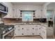 Modern kitchen featuring white cabinets, updated appliances and a stylish backsplash at 122 Vickery Dr, Fairburn, GA 30213