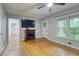 Cozy living room with hardwood floors, a modern fireplace and ample natural light at 122 Vickery Dr, Fairburn, GA 30213