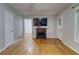 Open-concept living room with hardwood floors, a fireplace, and neutral paint at 122 Vickery Dr, Fairburn, GA 30213
