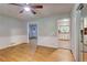Spacious living room boasts hardwood floors and classic trim, open to the front entry and kitchen at 122 Vickery Dr, Fairburn, GA 30213