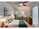 Bright staged bedroom with stylish decor, hardwood floors and natural lighting at 122 Vickery Dr, Fairburn, GA 30213