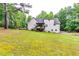 Spacious backyard featuring a deck and lush greenery, perfect for outdoor gatherings and relaxation at 2200 E Lake E Rd, Mcdonough, GA 30252