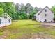 Spacious backyard featuring outbuildings, a shed, and ample green space, offering endless possibilities for outdoor activities at 2200 E Lake E Rd, Mcdonough, GA 30252