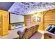 Finished basement featuring a home theater with wood paneled walls, cloud ceiling, and comfortable seating for entertaining at 2200 E Lake E Rd, Mcdonough, GA 30252