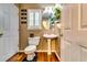 Cozy bathroom featuring vanity, pedestal sink, toilet, and wood-look floors at 2200 E Lake E Rd, Mcdonough, GA 30252