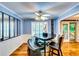 Modern dining room with wainscotting, unique light fixture, and wooden floors at 2200 E Lake E Rd, Mcdonough, GA 30252