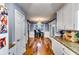 Charming kitchen hallway with granite counters, white cabinets and wood floors at 2200 E Lake E Rd, Mcdonough, GA 30252