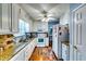 Well-lit kitchen with white cabinetry, granite countertops, stainless steel appliances, and hardwood floors at 2200 E Lake E Rd, Mcdonough, GA 30252