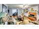 Comfortable living room features a brick fireplace, ceiling fan, and hardwood floors at 2200 E Lake E Rd, Mcdonough, GA 30252