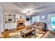 Open-concept living room showcases a fireplace, built-in shelves and hardwood floors at 2200 E Lake E Rd, Mcdonough, GA 30252