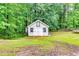 Backyard shed with double doors and a window, providing storage and potential workspace within the property at 2200 E Lake E Rd, Mcdonough, GA 30252