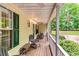 Relaxing porch with chairs, and white railings offering a view of the yard at 2200 E Lake E Rd, Mcdonough, GA 30252