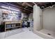 Unfinished basement featuring a workbench area, utility sink, and an enclosed shower at 4611 Dogwood Rd, Pine Lake, GA 30072