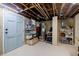 Unfinished basement offering ample storage space with shelving, water heater, and a door leading outside at 4611 Dogwood Rd, Pine Lake, GA 30072