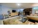 Basement living area featuring a stone fireplace, accent furniture, and area rug at 4611 Dogwood Rd, Pine Lake, GA 30072