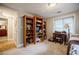 Bedroom features wooden shelves and a quaint desk area under a window, offering functional space at 4611 Dogwood Rd, Pine Lake, GA 30072