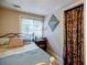 Well-lit bedroom with a comfortable bed, bedside table, and closet at 4611 Dogwood Rd, Pine Lake, GA 30072
