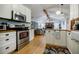 Modern kitchen with stainless steel appliances, white cabinets, and hardwood floors, ideal for cooking and entertaining at 4611 Dogwood Rd, Pine Lake, GA 30072
