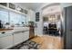 Bright kitchen area featuring a farmhouse sink, stainless appliances, and an adjacent dining area at 4611 Dogwood Rd, Pine Lake, GA 30072