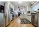 Bright kitchen with stainless steel appliances, white cabinets, and an open view to the living room at 4611 Dogwood Rd, Pine Lake, GA 30072