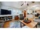 Comfortable living room featuring hardwood floors, large windows, and an open layout at 4611 Dogwood Rd, Pine Lake, GA 30072