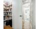 View of the pantry with well-stocked shelves and a doorway leading to another room at 4611 Dogwood Rd, Pine Lake, GA 30072