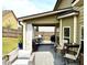 Cozy backyard with a covered patio, outdoor seating, and a well-maintained lawn at 558 Hideaway Dr, Jonesboro, GA 30238