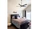 Elegant bedroom with a statement headboard, a plush bed, and a ceiling fan at 558 Hideaway Dr, Jonesboro, GA 30238