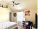 Charming bedroom with a ceiling fan, a comfortable bed, and a decorative accent wall at 558 Hideaway Dr, Jonesboro, GA 30238