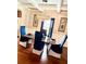 Dining room with a modern chandelier and six comfortable blue chairs around the table at 558 Hideaway Dr, Jonesboro, GA 30238