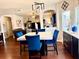 Open-concept dining area with a modern table and stylish blue chairs at 558 Hideaway Dr, Jonesboro, GA 30238