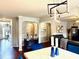 Dining area open to the living room with a modern light fixture and blue chairs at 558 Hideaway Dr, Jonesboro, GA 30238