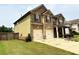 Side view of a two-story house showing a two-car garage and well-maintained lawn at 558 Hideaway Dr, Jonesboro, GA 30238