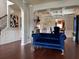 Elegant living room with hardwood floors and a stylish blue velvet couch at 558 Hideaway Dr, Jonesboro, GA 30238