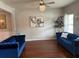 Sophisticated living room featuring hardwood floors, two blue couches, and natural light at 558 Hideaway Dr, Jonesboro, GA 30238