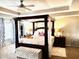 Elegant main bedroom with a four-poster bed, tray ceiling, and ample natural light at 558 Hideaway Dr, Jonesboro, GA 30238