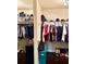 Well-organized walk-in closet with ample hanging space and storage shelves for clothing and accessories at 558 Hideaway Dr, Jonesboro, GA 30238