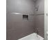 Modern bathroom with tiled shower, built-in niche, and sleek fixtures at 603 Summit North Ne Dr # 603, Atlanta, GA 30324