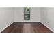 This bedroom with hardwood floors and a bright window offers natural light at 603 Summit North Ne Dr # 603, Atlanta, GA 30324