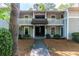 Two-story condo building with balconies and stairs, surrounded by lush greenery at 603 Summit North Ne Dr # 603, Atlanta, GA 30324