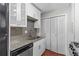 Bright kitchen features white cabinets, stainless steel appliances, and stylish granite countertops at 603 Summit North Ne Dr # 603, Atlanta, GA 30324