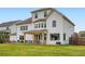 Expansive backyard featuring a wooden deck, dining area, lush green lawn, and a beautiful home exterior at 6168 Sweet Birch Ct, Acworth, GA 30101