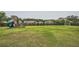 Expansive backyard with a large playset, trampoline, and lush green grass at 6168 Sweet Birch Ct, Acworth, GA 30101