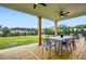 Outdoor patio with ceiling fans and a wooden deck, offering a comfortable space to dine and relax outdoors at 6168 Sweet Birch Ct, Acworth, GA 30101