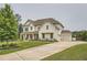Beautifully landscaped home exterior with a long driveway and an attached garage at 6168 Sweet Birch Ct, Acworth, GA 30101