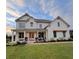 Charming white brick home with well-manicured lawn, covered front porch, and double doors at 6168 Sweet Birch Ct, Acworth, GA 30101