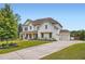 Inviting two-story home with a covered front porch, beautifully landscaped yard, and a long driveway at 6168 Sweet Birch Ct, Acworth, GA 30101
