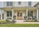 Inviting front porch with stylish decor, potted plants, and comfortable seating area at 6168 Sweet Birch Ct, Acworth, GA 30101